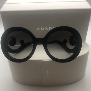 Prada Minimal Baroque SPR 27N.Has scrolled temples and Gradient grey lenses.